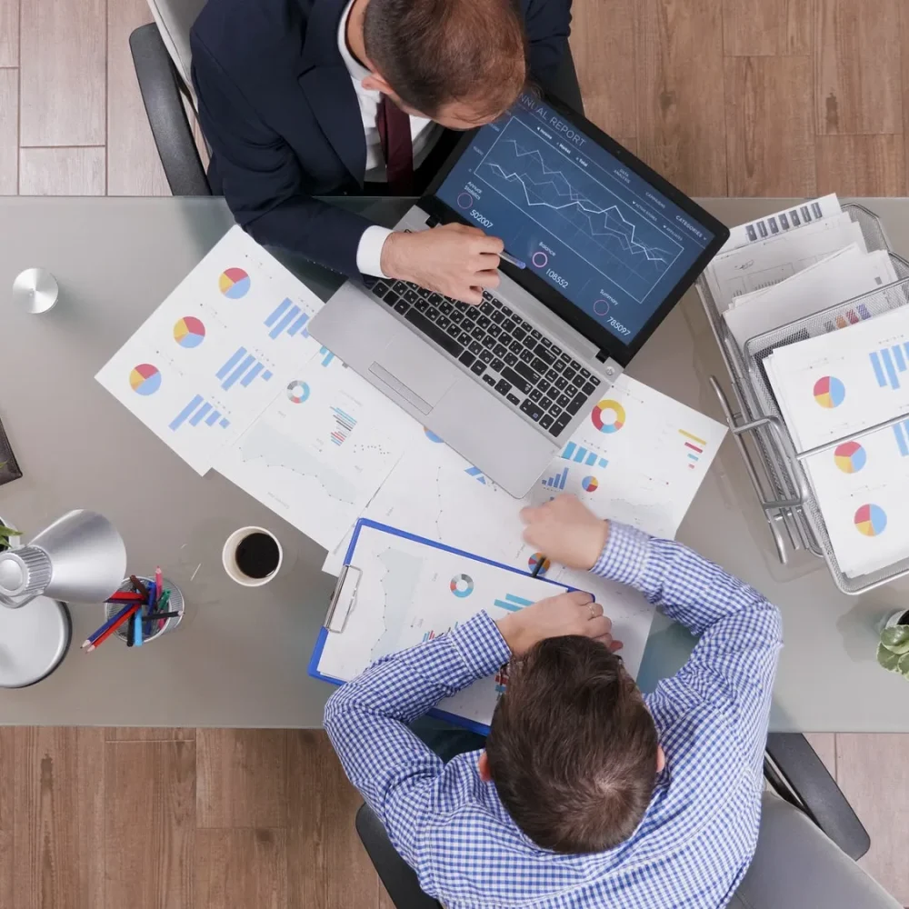 top-view-of-businessmen-analyzing-management-statistics-while-working-at-company-investments_684944c4ee915 top-view-of-businessmen-analyzing-management-statistics-while-working-at-company-investments_684944c4ee915